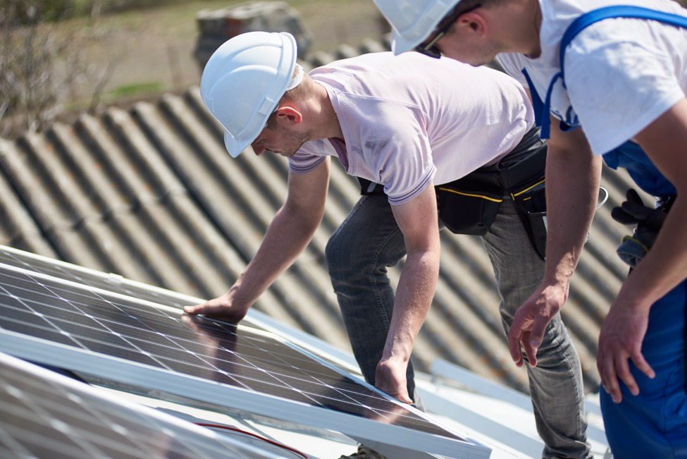 A construction worker installing solar panel