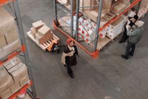 Three people working in a warehouse