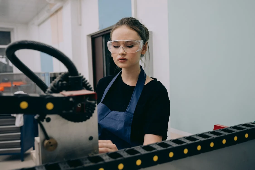 A person wearing glasses inside a factory