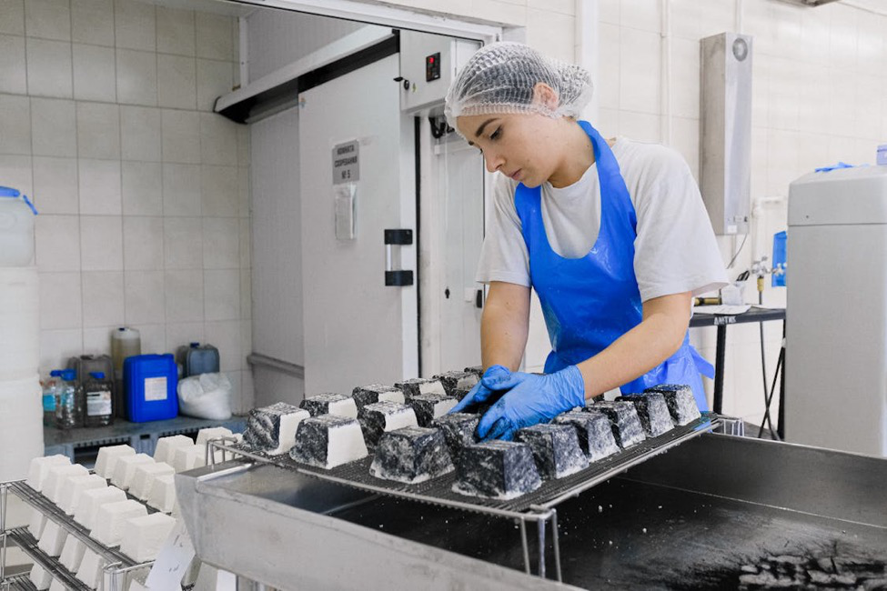  A person working with molds in a factory. 