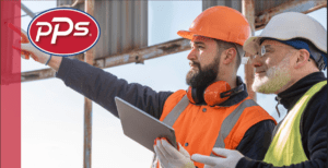 Construction workers wearing safety gear reviewing a project on site.