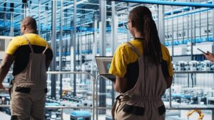 assembly line workers in a factory checking systems.